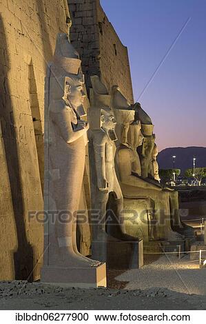 Stock Image - Temple of Luxor at dusk with colossal statues of Ramses ll, Luxor, Egypt, Africa. Fotosearch