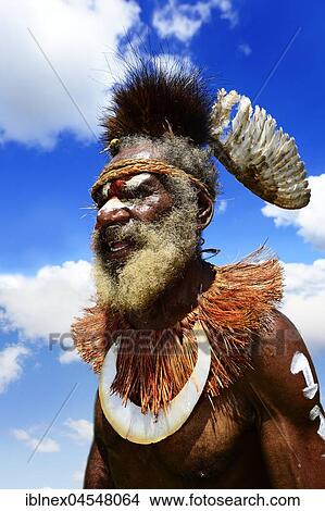 The Highland tribes, here a chieftain of the Wantrifu string band from the dhowlo District of Asaro, presents itself at the annual Sing Sing of Goroka, Papua New Guinea, Oceania View Large Photo Image Picture - The Highland tribes, here a chieftain of the Wantrifu string band from the dhowlo District of Asaro, presents itself at the annual Sing Sing of Goroka, Papua New Guinea, Oceania. Fotosearch