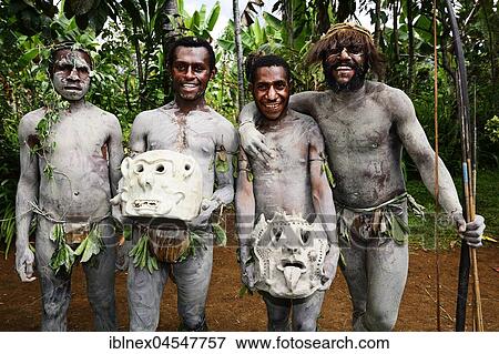 Stock Photo - The mud men, also called Mud Man of Asaro with their martial masks of clay, Goroka, in the highlands of Papua New Guinea. Fotosearch