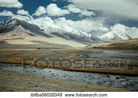 The Wachandarja River meanders through a wide gravel bed on a plateau of the Wakhan Corridor near Bozai Gumbaz, in the background the snow-covered peaks of the Hindu Kush forming the border with Pakistan, Wakhan Corridor, Badakhshan, Afghanistan, Asia View Large Photo Image Stock Photo - The Wachandarja River meanders through a wide gravel bed on a plateau of the Wakhan Corridor near Bozai Gumbaz, in the background the snow-covered peaks of the Hindu Kush forming the border with Pakistan, Wakhan Corridor, Badakhshan, Afghanistan, Asia. Fotosearch