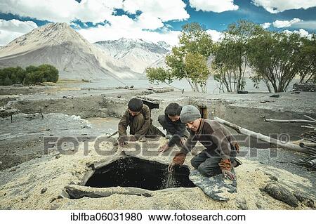 Three boys shovel wheat grains through the opening from above into a granary, members of the ethnic group of the sedentary Wakhi, Saradh-e-Broghil, Wakhan Corridor, Afghanistan, Asia View Large Photo Image Stock Image - Three boys shovel wheat grains through the opening from above into a granary, members of the ethnic group of the sedentary Wakhi, Saradh-e-Broghil, Wakhan Corridor, Afghanistan, Asia. Fotosearch