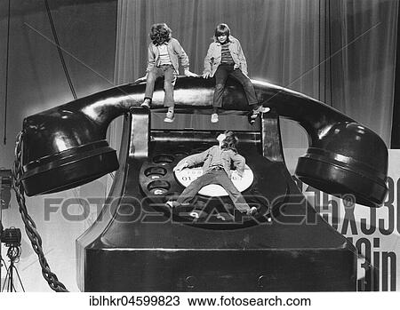 Three children on a large telephone, England, Great Britain View Large Photo Image Stock Image - Three children on a large telephone, England, Great Britain. Fotosearch