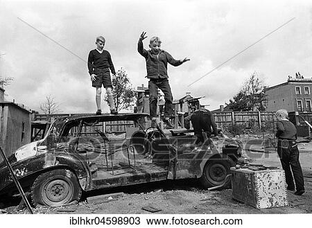 Three children play with car wreckage, England, Great Britain View Large Photo Image Stock Image - Three children play with car wreckage, England, Great Britain. Fotosearch