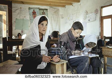 Three pupils in a school desk, classroom, Potokh Primary School, Potokh, Wakhan Corridor, Afghanistan, Asia View Large Photo Image Stock Image - Three pupils in a school desk, classroom, Potokh Primary School, Potokh, Wakhan Corridor, Afghanistan, Asia. Fotosearch