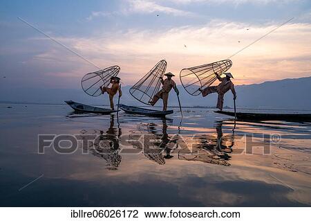 Three traditional fishermen pose standing on their small boats, at sunrise, Lake Inle, Myanmar, Asia View Large Photo Image Stock Image - Three traditional fishermen pose standing on their small boats, at sunrise, Lake Inle, Myanmar, Asia. Fotosearch