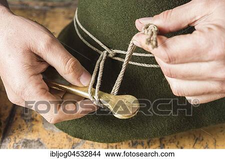 Picture - Tightening the shaping cord around a wool felt hat, using iron tool, hatmaker workshop, Bad Aussee, Styria, Austria, Europe. Fotosearch