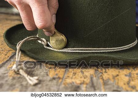 Stock Image - Tightening the shaping cord around a wool felt hat, using iron tool, hatmaker workshop, Bad Aussee, Styria, Austria, Europe. Fotosearch