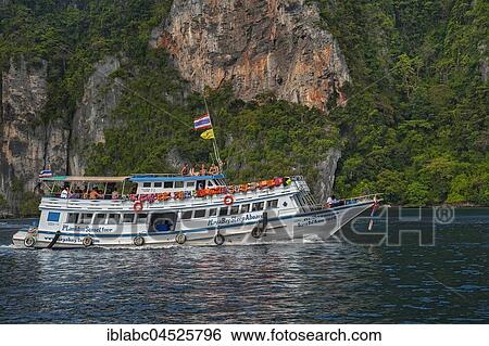 Stock Photograph - Tourist boat in front of rock face, Ko Phi Phi Island, Phuket, Thailand, Asia. Fotosearch