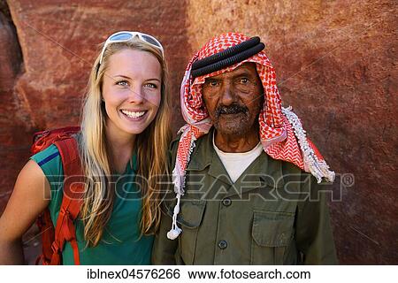 Tourist girl poses with old man, Bedouin, at colourful rock-formations in Petra, Wadi Musa, Jordan, Asia View Large Photo Image Stock Photograph - Tourist girl poses with old man, Bedouin, at colourful rock-formations in Petra, Wadi Musa, Jordan, Asia. Fotosearch