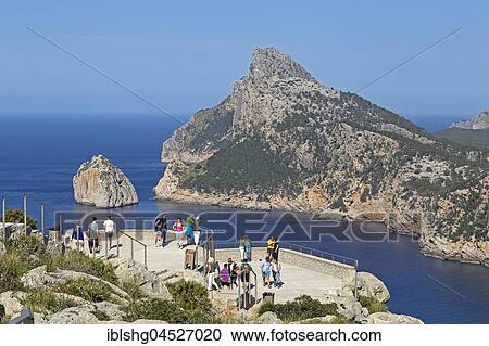 Stock Image - Tourists at the viewpoint, Mirador d' Es Colomer, also Mirador del Mal Pas, Peninsula Formentor, Majorca, Spain, Europe. Fotosearch