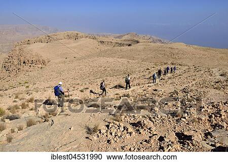 Tourists hiking above Wadi Tiwi, Al Hajar ash Sharqi mountains, Sharqiyah, Oman, Asia View Large Photo Image Stock Image - Tourists hiking above Wadi Tiwi, Al Hajar ash Sharqi mountains, Sharqiyah, Oman, Asia. Fotosearch