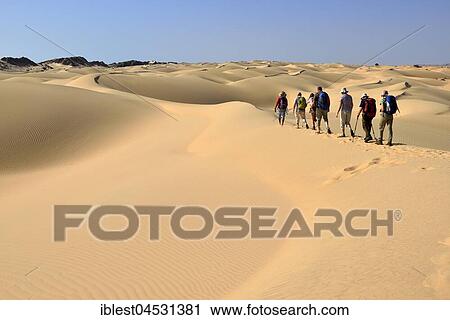 Tourists hiking in sanddunes, Al Khalut desert, Sharqiyah, Oman, Asia View Large Photo Image Stock Image - Tourists hiking in sanddunes, Al Khalut desert, Sharqiyah, Oman, Asia. Fotosearch