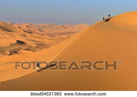 Tourists hiking in the sanddunes, Rub al Khali desert, empty quarter, Dhofar, Oman, Asia View Large Photo Image Stock Image - Tourists hiking in the sanddunes, Rub al Khali desert, empty quarter, Dhofar, Oman, Asia. Fotosearch