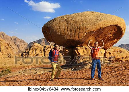 Tourists pose at Mushroom-Rock, Al Fetra, Wadi Rum, Jordan, Asia View Large Photo Image Picture - Tourists pose at Mushroom-Rock, Al Fetra, Wadi Rum, Jordan, Asia. Fotosearch