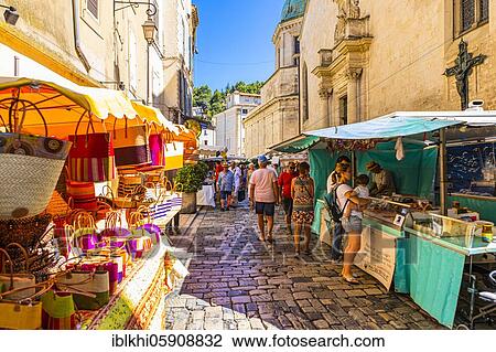 Tourists strolling through the stalls at the weekly market market in Apt, Luberon, Provence, France, Europe View Large Photo Image Stock Image - Tourists strolling through the stalls at the weekly market market in Apt, Luberon, Provence, France, Europe. Fotosearch
