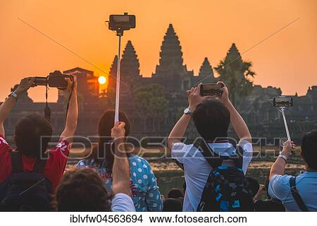 Picture - Tourists take pictures of Angkor Wat, Sunrise, Angkor Wat, Angkor Archaeological Park, Province Siem Reap, Cambodia, Asia. Fotosearch