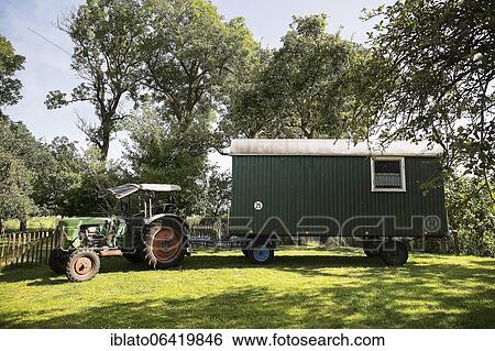 Tractor and removed construction trailer, caravan in a meadow, Schleswig-Holstein, Germany, Europe View Large Photo Image Stock Photograph - Tractor and removed construction trailer, caravan in a meadow, Schleswig-Holstein, Germany, Europe. Fotosearch