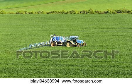 Tractor with field sprayer, spraying out pesticides, grain field in spring, Saxony-Anhalt, Germany, Europe View Large Photo Image Picture - Tractor with field sprayer, spraying out pesticides, grain field in spring, Saxony-Anhalt, Germany, Europe. Fotosearch