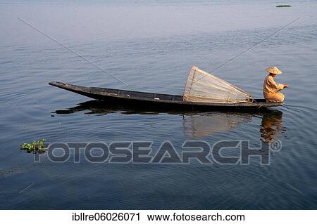 Stock Image - Traditional fisherman on his small boat, Lake Inle, Myanmar, Asia. Fotosearch