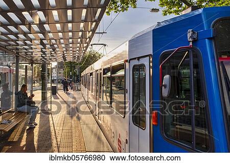 Tram of the Rheinbahn at the stop Nikolaus-Kopp-Platz in the district Heerdt, Düsseldorf, North Rhine-Westphalia, Germany, Europe View Large Photo Image Stock Image - Tram of the Rheinbahn at the stop Nikolaus-Kopp-Platz in the district Heerdt, Düsseldorf, North Rhine-Westphalia, Germany, Europe. Fotosearch