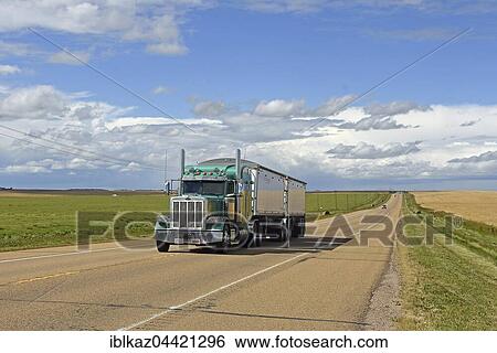 Truck drives on straight road, Alberta, Canada, North America View Large Photo Image Stock Photograph - Truck drives on straight road, Alberta, Canada, North America. Fotosearch