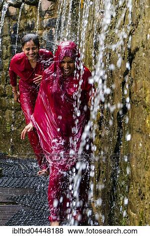 Two female pilgrims running through the 108 holy wells, showering for purifying body and soul, Muktinath, Mustang District, Nepal, Asia View Large Photo Image Stock Photo - Two female pilgrims running through the 108 holy wells, showering for purifying body and soul, Muktinath, Mustang District, Nepal, Asia. Fotosearch