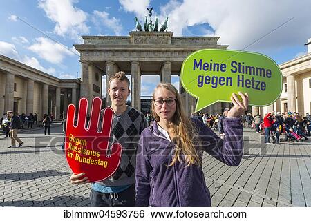 Stock Photograph - Two students with shield My vote against hate, against racism in the Bundestag, Anti AFD-Demo, Brandenburg Gate, Berlin, Germany, Europe. Fotosearch