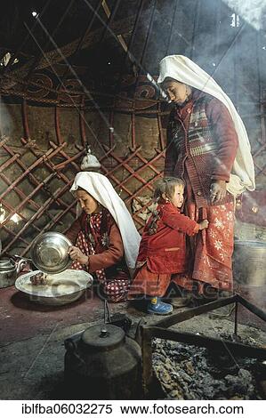 Two woman and a child in traditional Kyrgyz traditional traditional traditional traditional traditional traditional traditional traditional traditional costume, dough making for flat bread, in front of her a teakettle on a fireplace, yurt, bozai... View Large Photo Image Stock Photography - Two woman and a child in traditional Kyrgyz traditional traditional traditional traditional traditional traditional traditional traditional traditional costume, dough making for flat bread, in front of her a teakettle on a fireplace, yurt, bozai.... Fotosearch