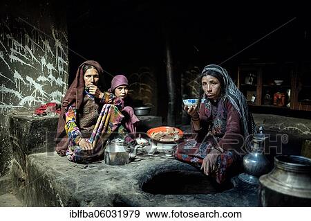 Two woman and a girl, smokehouse, traditional mud house, the girls drink milk tea, Sarad-e-Broghil, Wakhan corridor, Afghanistan, Asia View Large Photo Image Stock Photo - Two woman and a girl, smokehouse, traditional mud house, the girls drink milk tea, Sarad-e-Broghil, Wakhan corridor, Afghanistan, Asia. Fotosearch