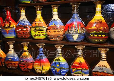 Stock Photography - Typical Souvenir, handcrafted sand bottles with desert-motives, camels and palmtrees, Jordan, Asia. Fotosearch