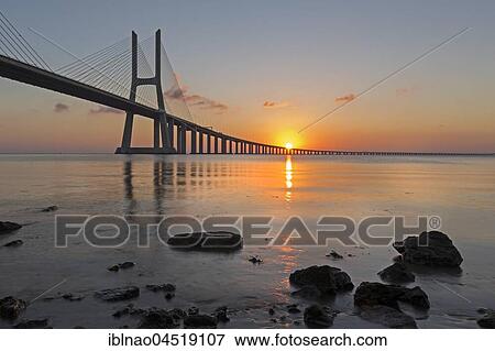 Stock Photo - Vasco da Gama bridge over the Tagus River, Sunset, Lisbon, Portugal, Europe. Fotosearch