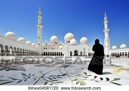 Stock Image - Veiled woman in front of the Sheikh-Zayed Mosque, Emirate Abu Dhabi, United Arab Emirates, Asia. Fotosearch