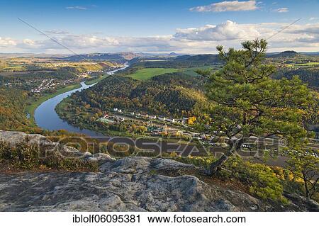 View from the autumnal Lilienstein with Wetterkiefer on the Elbe river near Königstein to Bad Schandau and over the German-Czech border with Mount Ruzova, Ruzak, National Park Saxon Switzerland, Saxony, Germany, Europe View Large Photo Image Stock Image - View from the autumnal Lilienstein with Wetterkiefer on the Elbe river near Königstein to Bad Schandau and over the German-Czech border with Mount Ruzova, Ruzak, National Park Saxon Switzerland, Saxony, Germany, Europe. Fotosearch