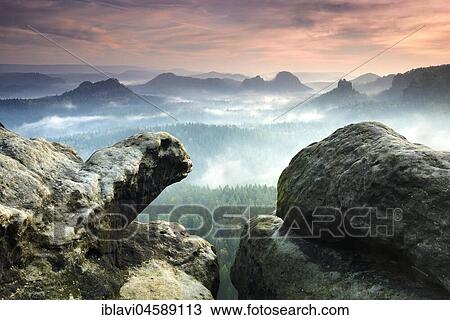 Stock Image - View from the Kleines Winterberg at sunrise, morning mist, Elbe Sandstone Mountains, Saxon Switzerland National Park, Saxony, Germany, Europe. Fotosearch