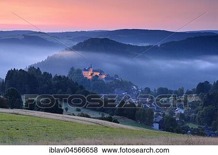 Stock Photo - View of castle and village Lauenstein, sunrise, morning mist, Ludwigsstadt, Upper Franconia, Bavaria, Germany, Europe. Fotosearch