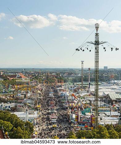 Stock Image - View of street with fairground rides on the Oktoberfest, Wiesn, Munich, Upper Bavaria, Bavaria, Germany, Europe. Fotosearch