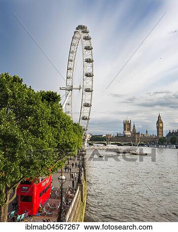 Stock Photo - View over the Thames from Golden Jubilee Bridge, promenade with Ferris wheel London Eye, at the back Big Ben and Houses of Parliament, London, England, Great Britain. Fotosearch