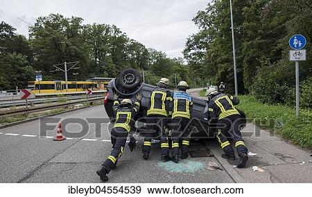 VW Polo lying on the roof after accident, fire brigade turning car, Germany, Europe View Large Photo Image Stock Photo - VW Polo lying on the roof after accident, fire brigade turning car, Germany, Europe. Fotosearch