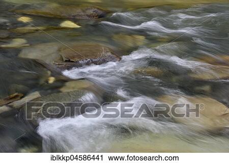 Stock Image - Water flows over stones, Abiskojakka River, Abisko National Park, Sweden, Europe. Fotosearch