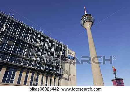 Stock Image - WDR Düsseldorf, West German Radio, Rhine Tower and sculpture by Christoph Pöggeler, Column Saint, Media Harbour Düsseldorf, North Rhine-Westphalia, Germany, Europe. Fotosearch