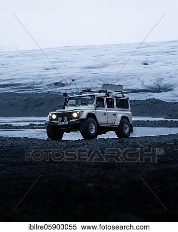 Stock Photography - White Land Rover Jeep in front of a glacier, Vatnajökull glacier, Iceland, Europe. Fotosearch