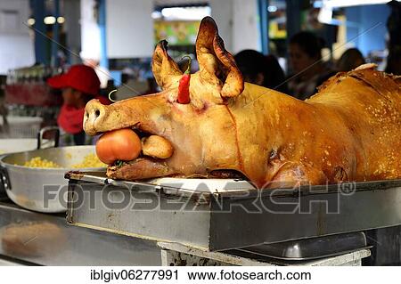 Stock Image - Whole sucking pig at a market stall, Otavalo, Imbabura Province, Ecuador, South America. Fotosearch