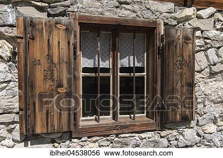 Stock Photograph - Window with wooden carvings at an alpine cabin, Engalm, Karwendel, Tyrol, Austria, Europe. Fotosearch