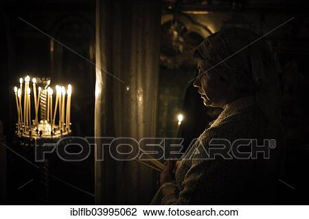 Stock Image - Woman in Prayer, Kiev Cave Monastery, Kijewo-Petscherska Lawra, Kiev, Ukraine, Europe. Fotosearch