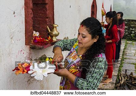Woman is offering prasad to the statues of gods at hinduist festival Darsain, temple Khadga Devi Mandir, hinduist festival Darsain, Bandipur, Tanahun District, Nepal, Asia View Large Photo Image Stock Photo - Woman is offering prasad to the statues of gods at hinduist festival Darsain, temple Khadga Devi Mandir, hinduist festival Darsain, Bandipur, Tanahun District, Nepal, Asia. Fotosearch
