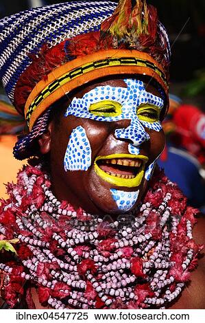 Stock Photography - Woman of the Marowa Welda applying makeup for the annual sing-sing Festival in Goroka, Papua New Guinea, Oceania. Fotosearch