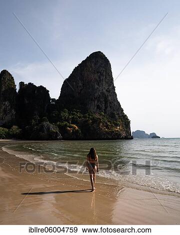 Stock Photo - Woman walking along the beach, tropical beach, Railay Beach, Krabi Province, Thailand, Asia. Fotosearch