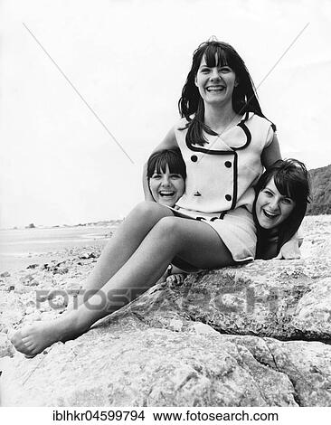 Woman with her sisters, triplets, England, Great Britain View Large Photo Image Picture - Woman with her sisters, triplets, England, Great Britain. Fotosearch