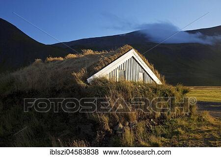 Wooden house with traditional grass turf roof in hilly landscape, Reykjadiskur, Island View Large Photo Image Stock Photo - Wooden house with traditional grass turf roof in hilly landscape, Reykjadiskur, Island. Fotosearch