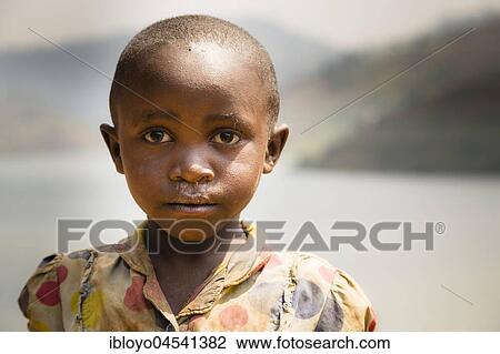 Stock Image - Young boy, Batwa Pygmy, Lake Bunyonyi, Uganda, Africa. Fotosearch